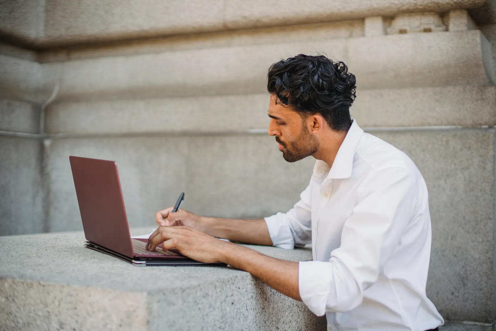 A student studying with a laptop in a shared workspace